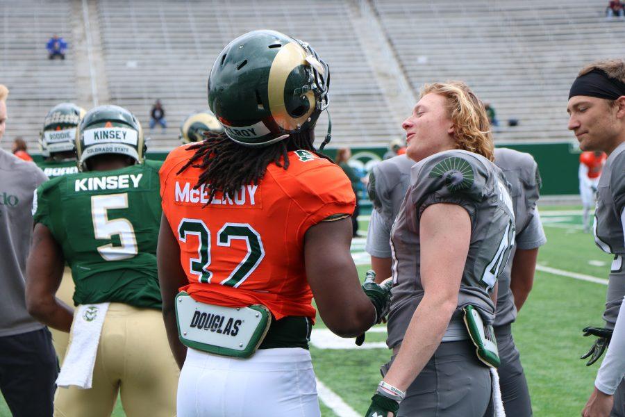 Marcus Mcelroy talks with a teammate during the spring football game. (Devin Cornelius | Collegian)