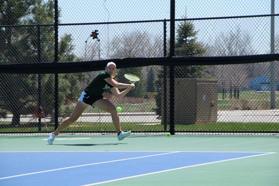 Freshman, Emily Luetschwager, runs to an outside shot and prepares to send it back to her opponent during her singles match against Wyoming on Apr 22 (Joshua Contreras | Collegian)