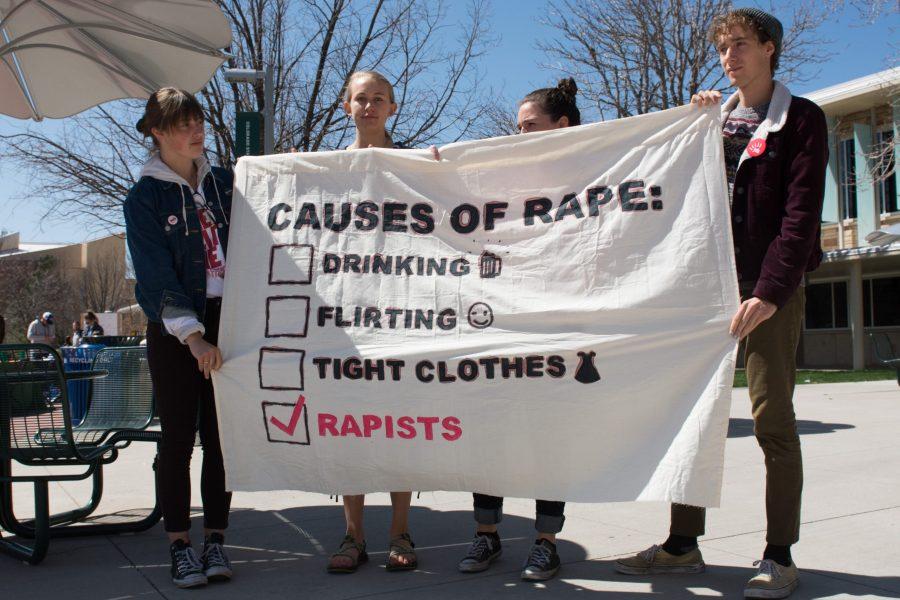 Vada Smith, Lilly Geer, Whitney Gustafson and Larson Ross hold a banner inside of the Lory Student Center food court on April 25 to protest sexual assault on college campuses. The Women and Gender Advocacy Center at CSU held the silent protest for Sexual Assault Awareness Month. (Colin Shepherd | Collegian)