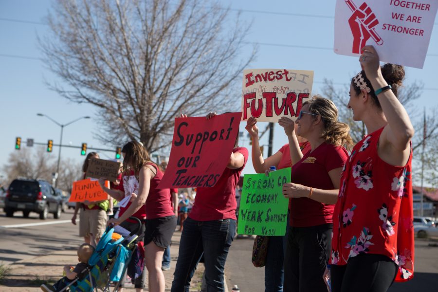 People that were unable to attend the rally for better pay for teachers in Denver organized a rally that took place on the corner of College and Drake on Friday, April 27. All of the people in attendance dressed in red, demonstrating unity that spaned several generations. (Josh Schroeder | Collegian)