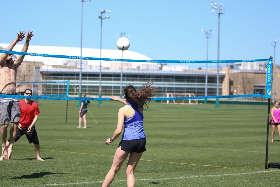 A particapant bumps the ball over the net at the RAM slam volleball tournament. (Devin Cornelius | Collegian)