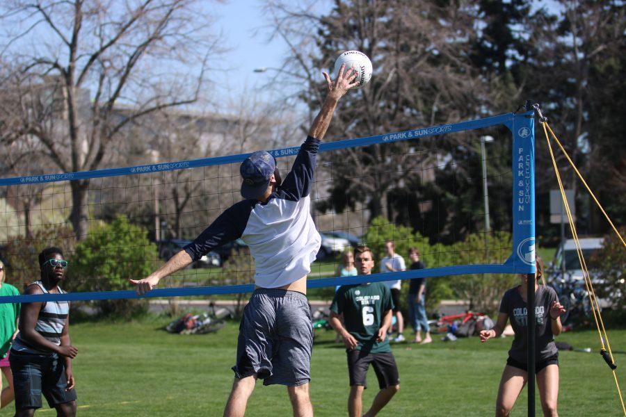 A student spikes the ball down towards the opponents side during the RAMslam volleyball tournament. (Devin Cornelius | Collegian)