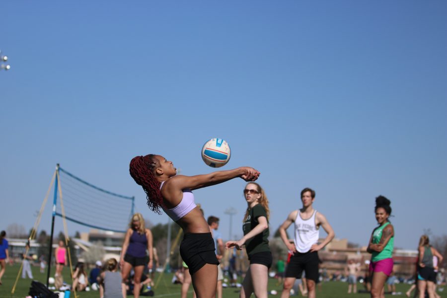 A student bumps the ball over the net during the RAMslam volleyball tournament (Devin Cornelius | Collegian)