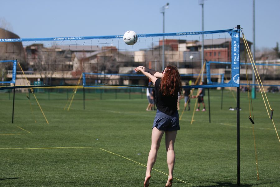 A student sets the ball for her team at the RAM slam volleball tournament ( Devin Cornelius | Collegian)