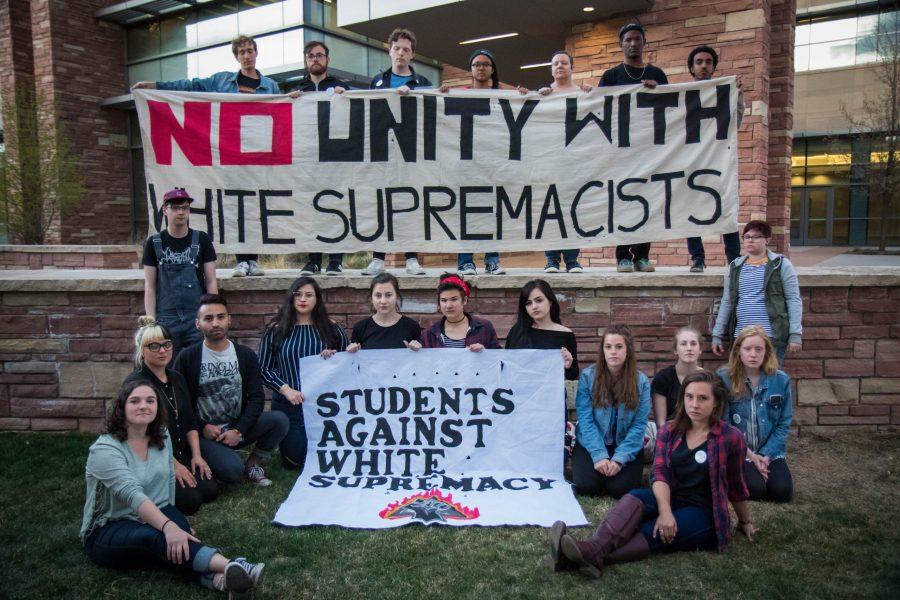 Students Against White Supremacy, a coalition of students who aim to expose and remove white supremacy on campus, hold the banners they've been displaying for events like disrupting CSUnite and tabling on the plaza to further education on these issues. (Julia Trowbridge | Collegian)