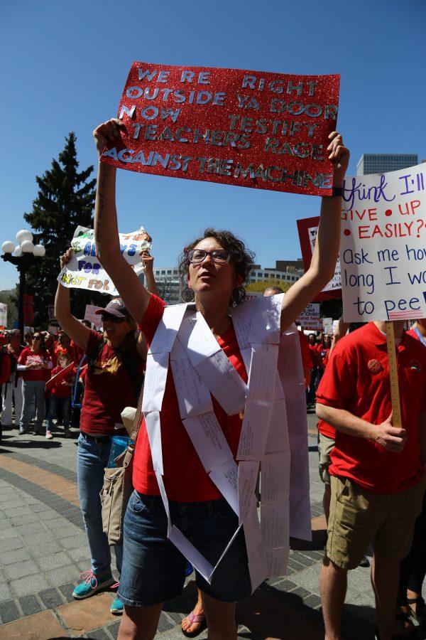Tanya Jorres, a teacher at JFK High School in Denver, wears letters written by graduating seniors that outline everything they didnt have that would have helped them during their time in school. Jorrres joins thousands of teachers, students and community members during the second state-wide teacher walkout to demand higher pay and better funding for schools. (Davis Bonner | Collegian)