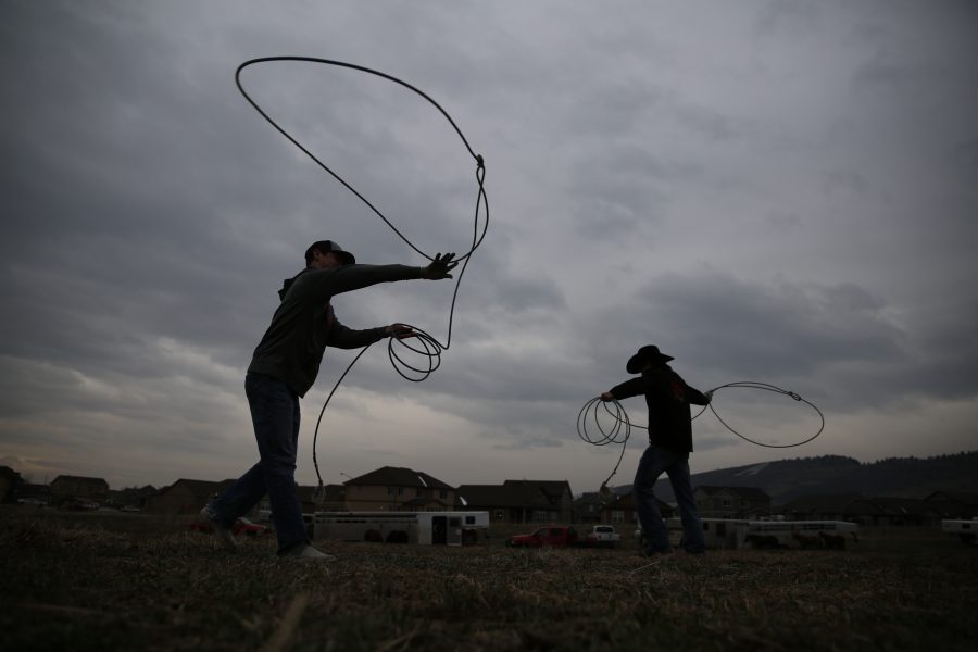 Riley Ruland, left, and Garett Ludwig, right, practice their roping skills before the 68th annual Skyline Stampede rodeo on April 7, 2018 at the B.W. Pickett Arena in Fort Collins.  (Forrest Czarnecki | The Collegian)