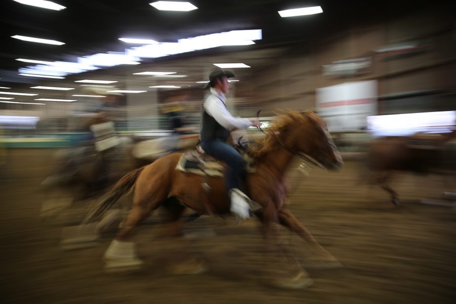 Cowboys and cowgirls warm up their horses behind the arena before the start of the 68th annual Skyline Stampede rodeo on April 7, 2018 at the B.W. Pickett Arena in Fort Collins.  (Forrest Czarnecki | The Collegian)