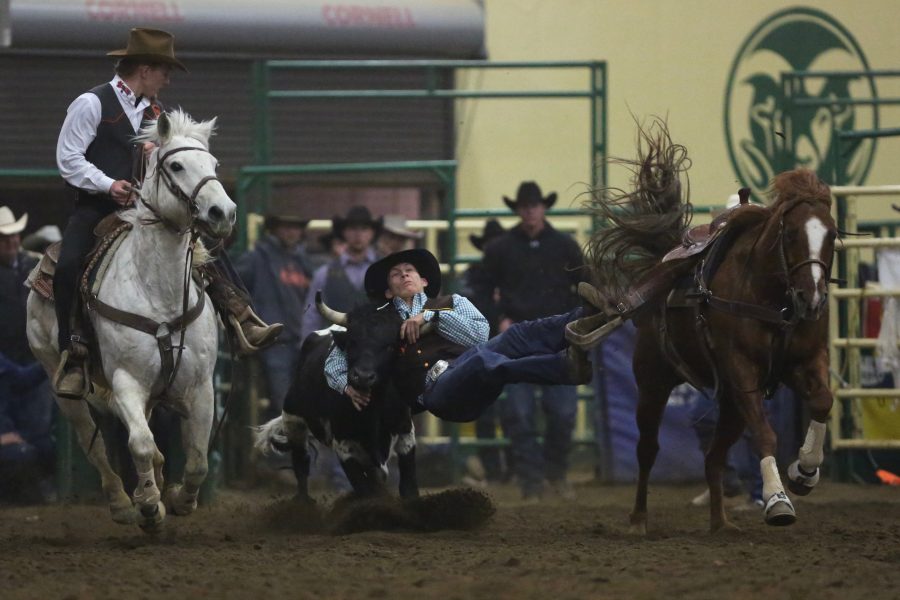 JC Flake, from the University of Wyoming, grabs a hold of his steer during the steer wrestling event at the 68th annual Skyline Stampede rodeo on April 7, 2018 at the B.W. Pickett Arena in Fort Collins.  (Forrest Czarnecki | The Collegian)
