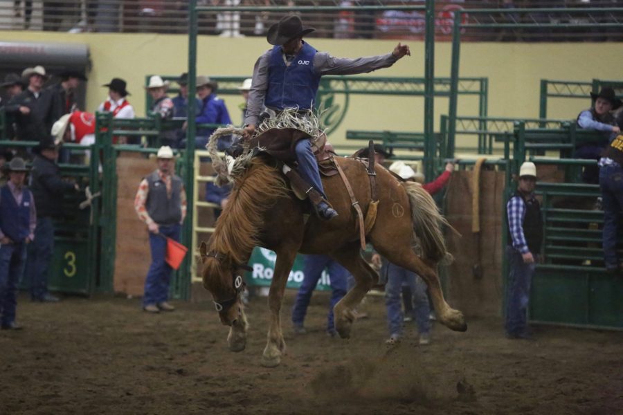 Clay West, from Otero Junior College, rides in the saddle bronc event at the 68th annual Skyline Stampede rodeo on April 7, 2018 at the B.W. Pickett Arena in Fort Collins.  (Forrest Czarnecki | The Collegian)