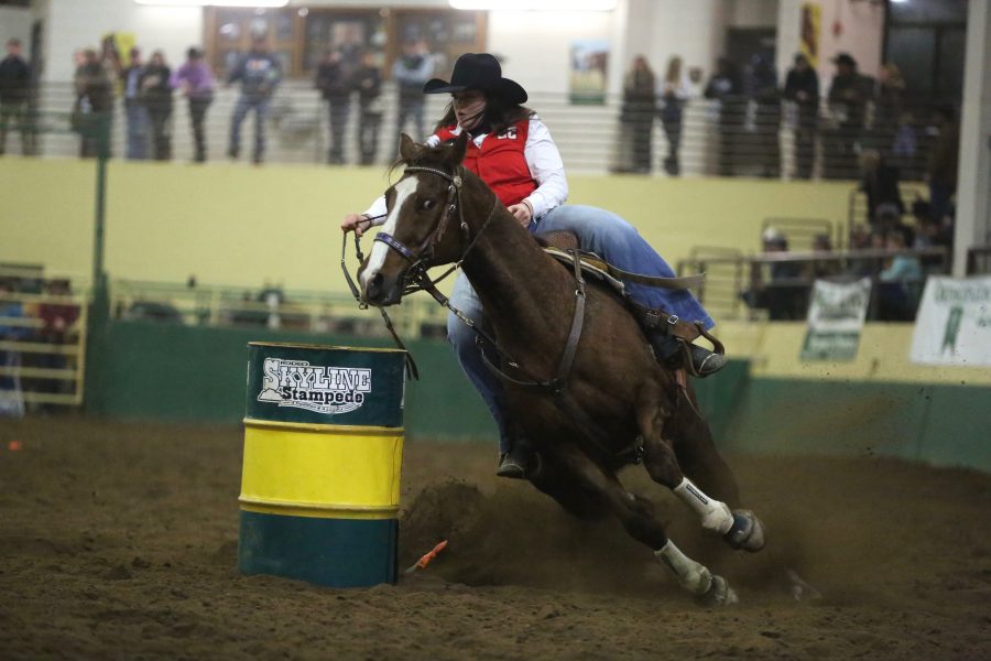 Kassi McPherson, from Casper College, competes in barrel racing at the 68th annual Skyline Stampede rodeo on April 7, 2018 at the B.W. Pickett Arena in Fort Collins.  (Forrest Czarnecki | The Collegian)