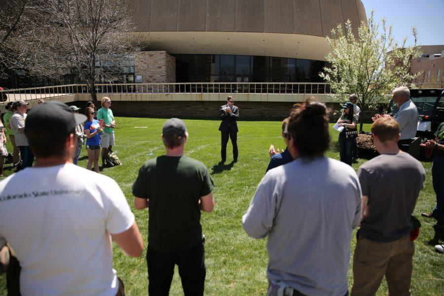 Colorado State University professor Matt Camper, center, leads the crowd in applause while discussing the planting of new trees along Plum Street during Earth Week on April 27, 2018.  (Forrest Czarnecki | The Collegian)