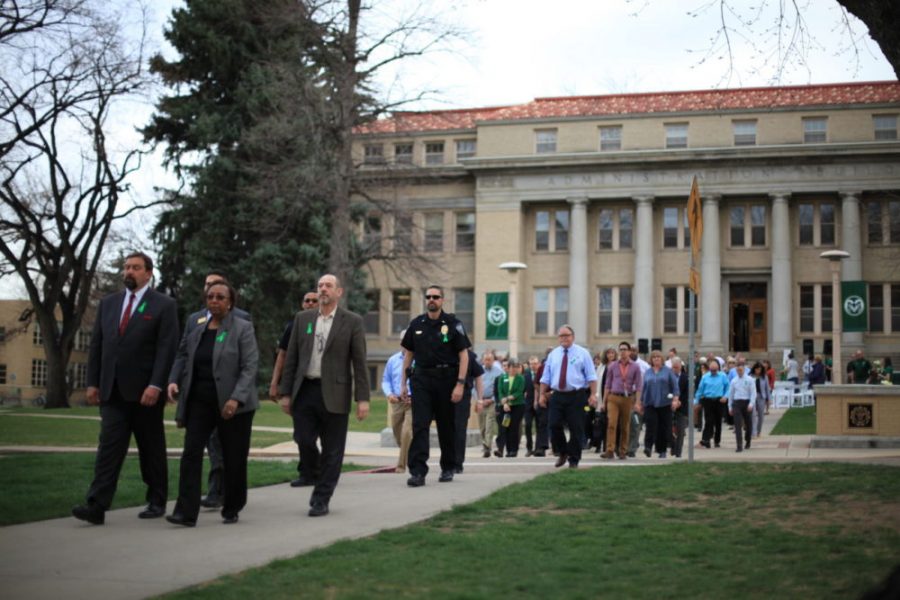 CSU President Tony Frank and Vice President of Student Affairs Blanche Hughes lead community members in a procession down the oval during Remember Rams event on April 10, 2018. (Natalie Dyer | Collegian)