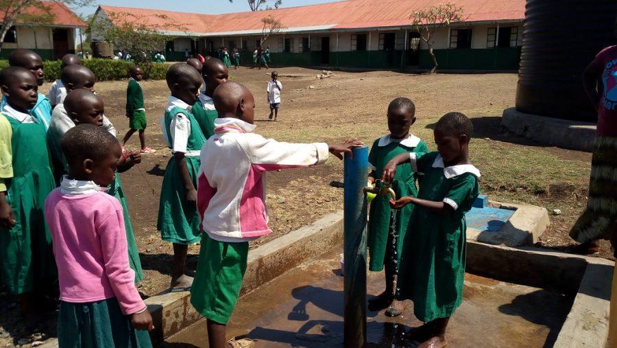 Children in the village of Kunya, Kenya collect water from the village pump constructed by Hach. 