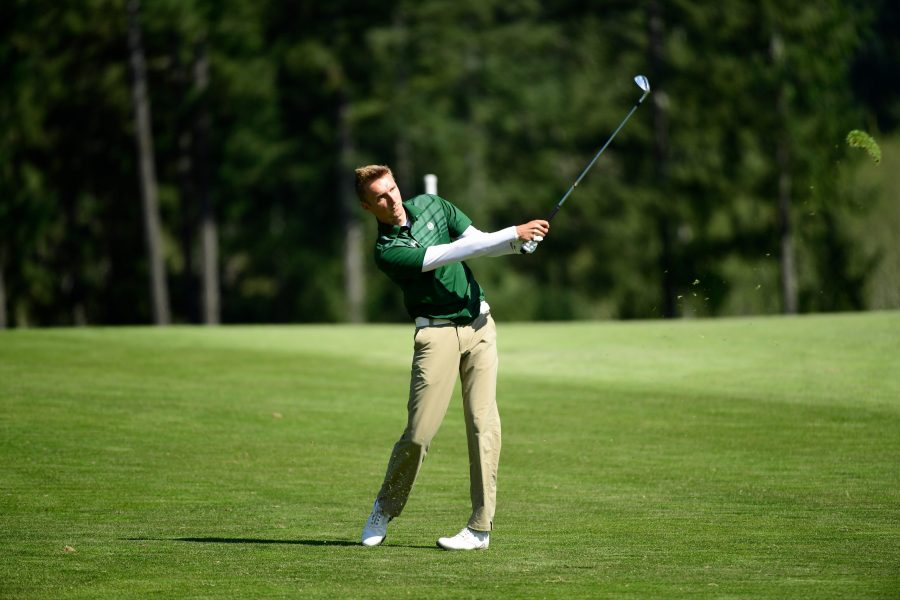Senior Max Oelfke finishes a swing during the 2018 Mountain West Championships at the Gold Mountain Golf Club in Bremerton, Washington. (Justin Tafoya/NCAA Photos)
