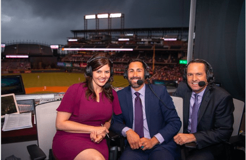Jenny Cavnar (left) sits with Ryan Spilborghs (middle) and Jeff Huson (right) in the Rockies broadcast booth on April 23, 2018. (Photo courtesy of Jenny Cavnar)