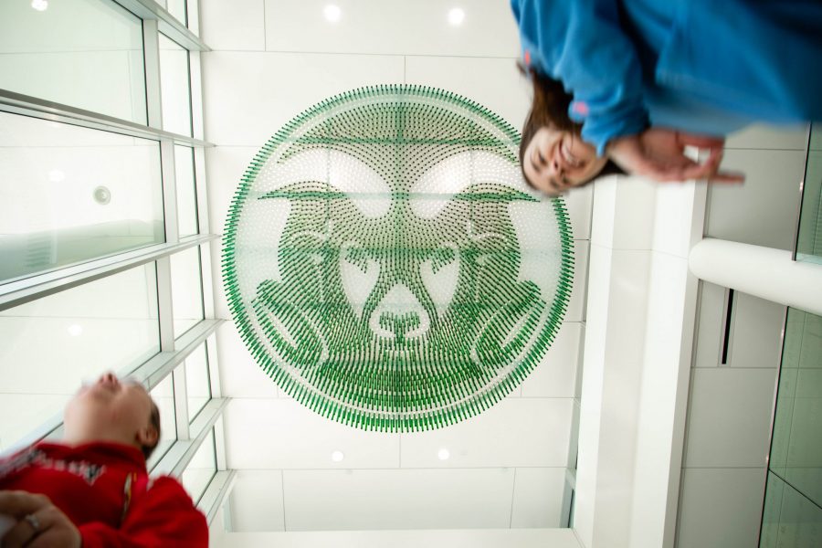 Students walk under the Colorado State University Cam the Ram logo on the ceiling of the Lory Student Center. Colorado State will celebrate I Love CSU day on Wednesday, April 18th.(Brooke Buchan | Collegian)