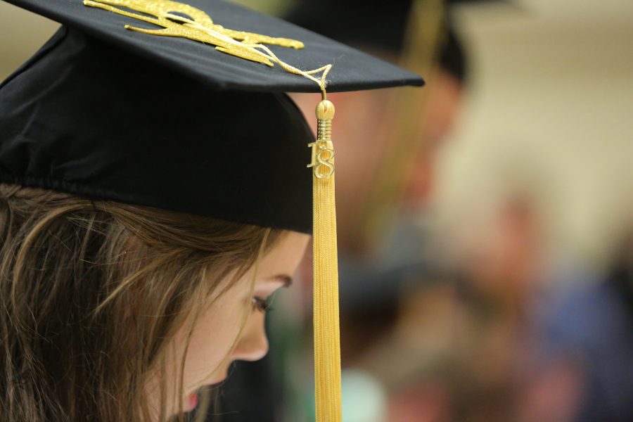 A Colorado State University graduate looks for her name card before the graduation ceremony for the College of Agricultural Sciences on May 12, 2018 at Moby Arena.  (Forrest Czarnecki | The Collegian)