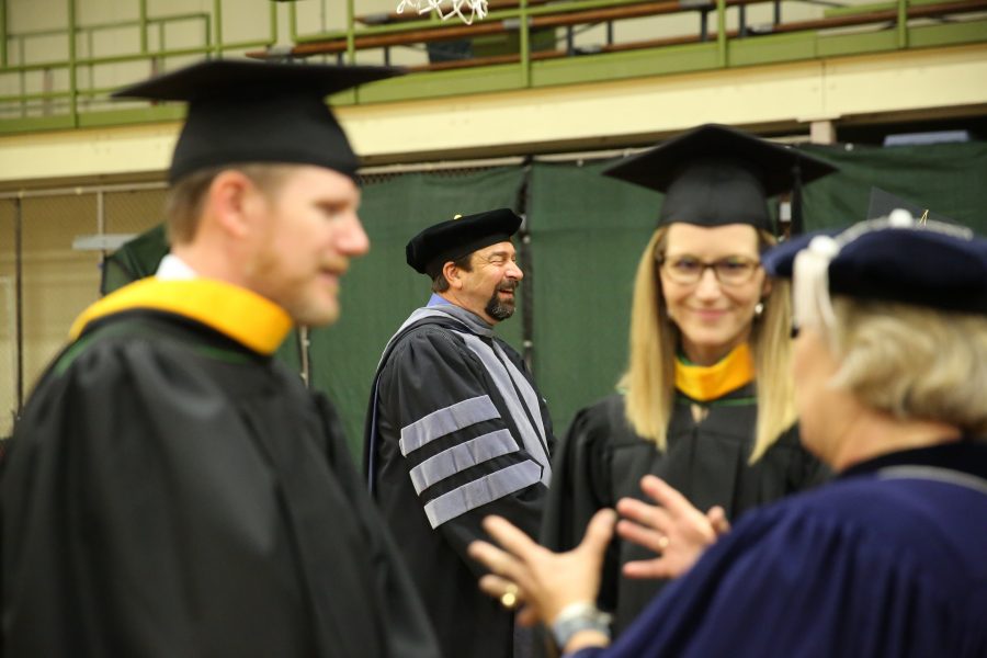Colorado State University Tony Frank (center) laughs with faculty members before the graduation ceremony for the College of Agricultural Sciences on May 12, 2018 at Moby Arena.  (Forrest Czarnecki | The Collegian)