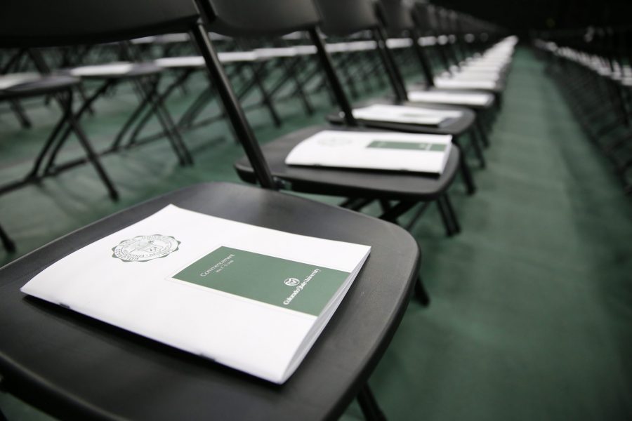 Programs fill the seats reserved for graduates at Moby Arena before a graduation ceremony begins May 13, 2018. (Collegian file photo)