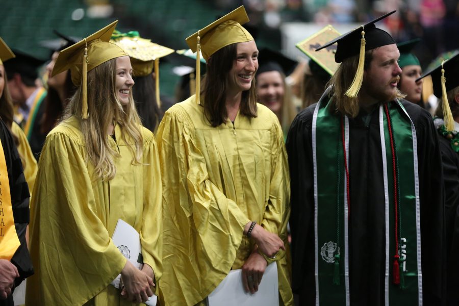 Colorado State University students from the College of Agricultural Sciences smile and laugh as they enter Moby Arena before their graduation ceremony begins on May 12, 2018.  (Forrest Czarnecki | The Collegian)
