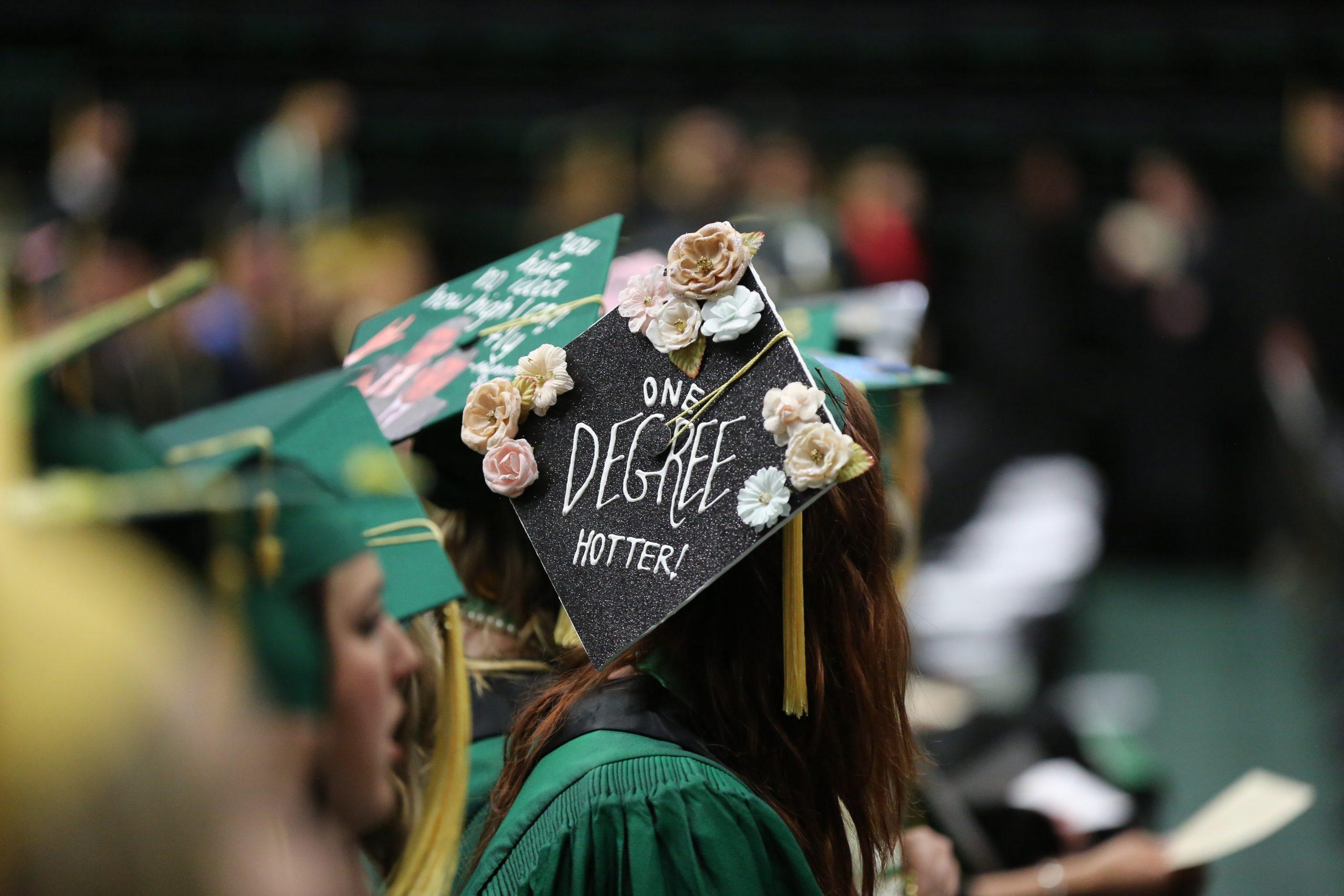 A graduate shows off their cap at graduation.