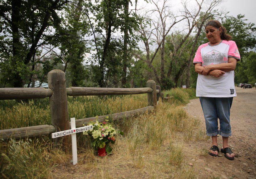 Evelyn Sinnett grieves while looking over the memorial that her and her family set up at Legacy Park for Cordell Starkey. Fort Collins police found the body of Starkey in the river on June 24th after he was reported missing days earlier. Sennett said that she was neighbors with Starkey and that he was "a great neighbor, and a wonderful person."  (Forrest Czarnecki | The Collegian)