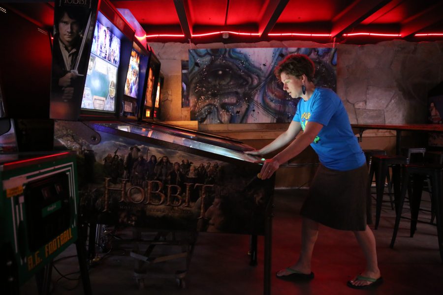 Natasha Kalda plays a game of pinball as part of the summer league of competitive pinball at the Pinball Jones Campus West location.  (Forrest Czarnecki | The Collegian)
