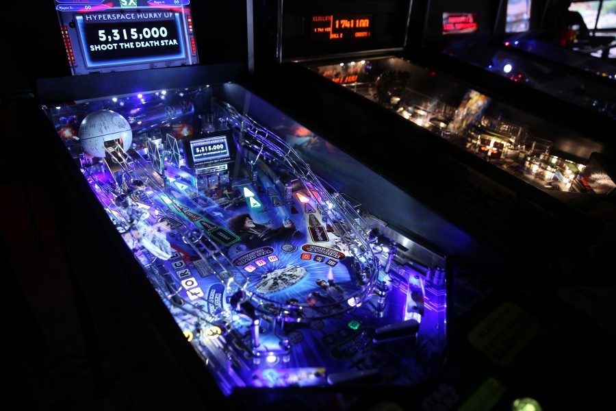 A pinball machine lights up with a high score following a game of pinball at the Pinball Jones Campus West location.  (Forrest Czarnecki | The Collegian)