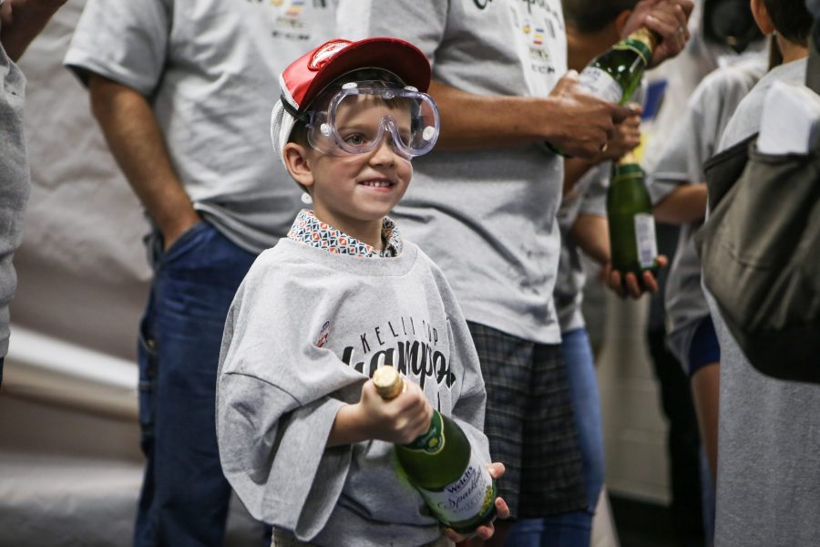 Young cancer patient awaits celebrating with a bottle of champagne during UCHealth and Colorado Eagles celebration PHOTO COURTESY OF Tony Villalobos-May Colorado Eagles