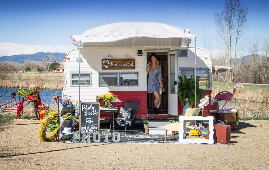 Northern Colorado businesswoman Leslie Reeves poses with her camper that she renovated for 10 months to create The Weathered Oak, a photo booth on the go. (Photo courtesy of Leslie Reeves)
