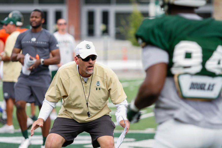 Coach Mike Bobo tells a player to get low during a drill at practice on August 2, 2018. (Ashley Potts | Collegian)