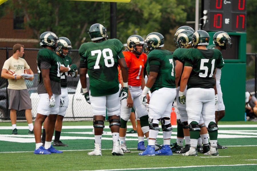 K.J. Carta-Samuels huddles with his offensive line before a drill at practice on August 2. (Ashley Potts | Collegian)