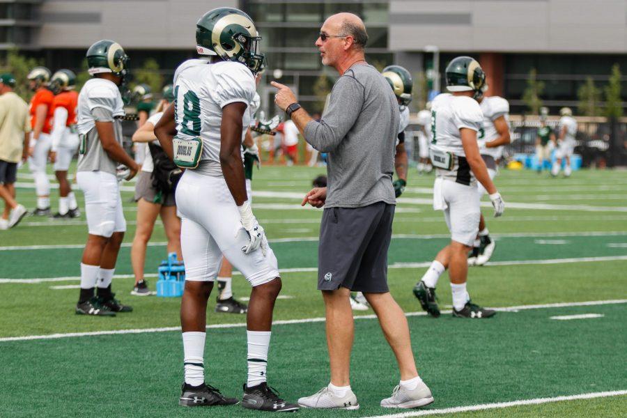 Defensive Coordinator John Jancek makes a suggestion to Braylin Scott after a drill at practice on August 2. (Ashley Potts | Collegian)