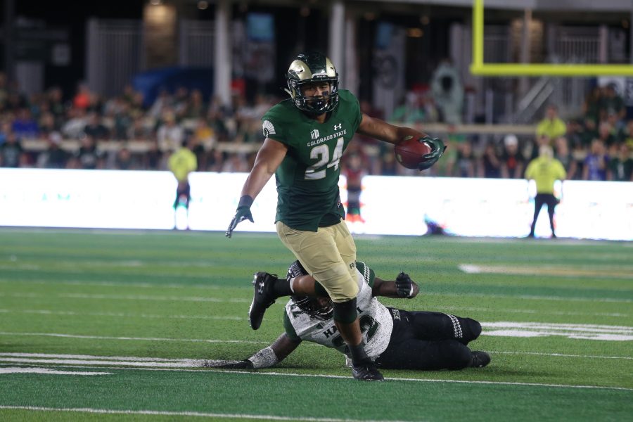 Colorado State Running Back Izzy Matthews breaks a tackle to continue moving up field against the Hawaii Rainbow Warriors. The Rams fell to the Warriors 43-34 at Canvas Stadium on August 25, 2018 in Fort Collins, CO. (Elliott Jerge | Collegian)