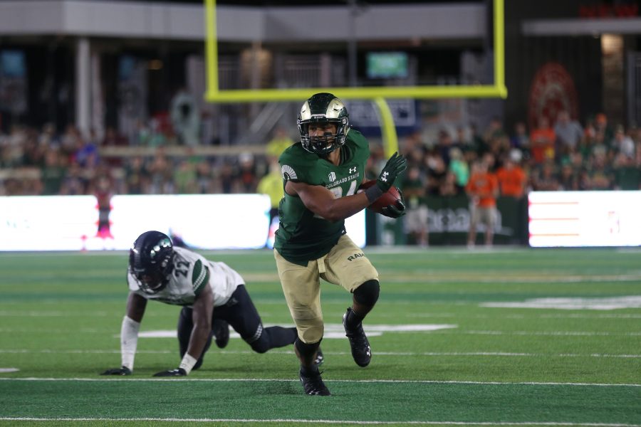 Colorado State Running Back Izzy Matthews breaks a tackle to continue moving up field against the Hawaii Rainbow Warriors. The Rams fell to the Warriors 43-34 at Canvas Stadium on August 25, 2018 in Fort Collins, CO. (Elliott Jerge | Collegian)