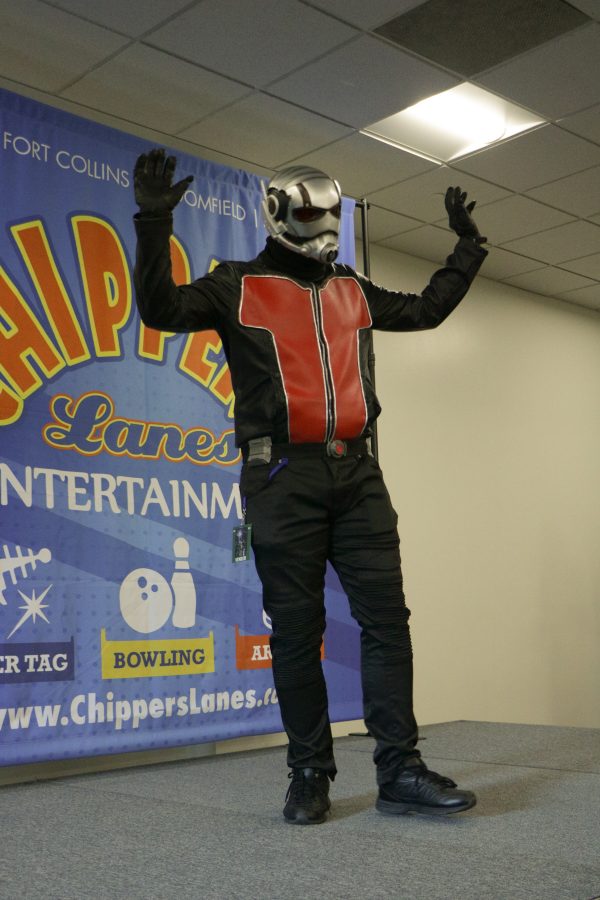 DJ waves to the audience from the catwalk while he is cosplaying as Antman. (Devin Cornelius | Collegian)