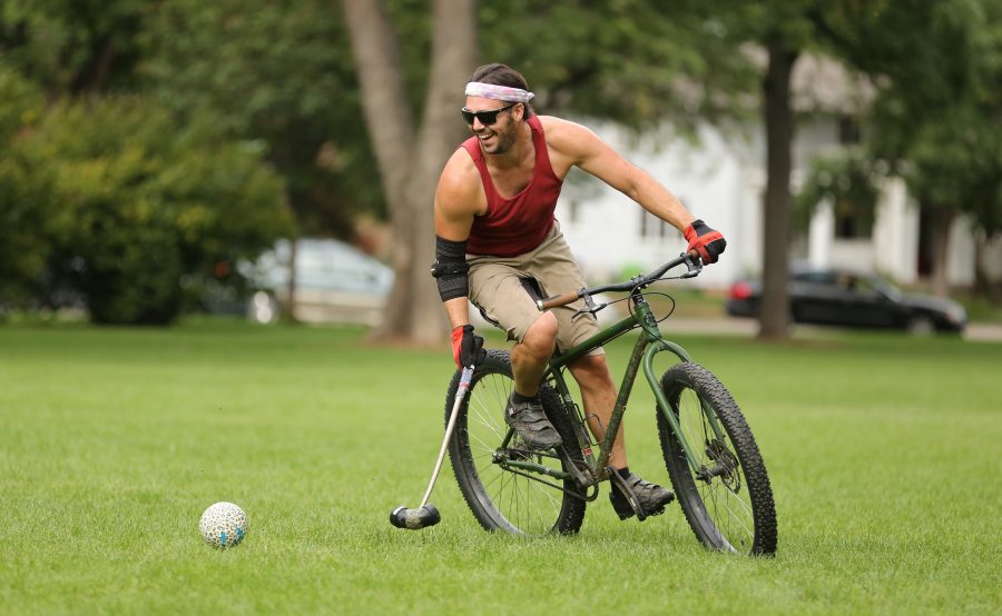 Sean Hulings laughs while competing in a game of bike polo with some of his friends at City Park on Aug. 26.  (Forrest Czarnecki | The Collegian)