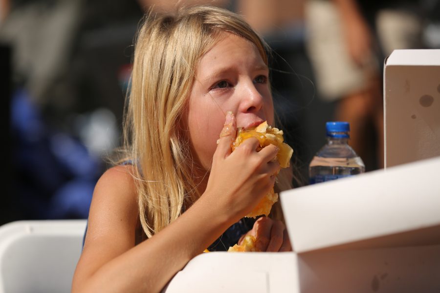 Jayna Jamison competes in the peach pie eating contest at the 2018 Fort Collins Peach Festival on Aug. 18.  (Forrest Czarnecki | The Collegian)