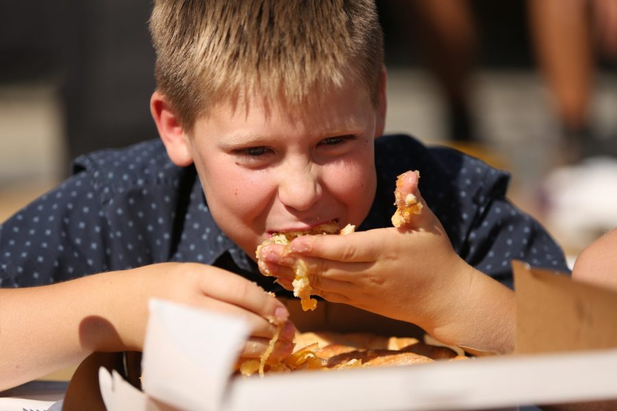 Elijah Caucutt competes in the peach pie eating contest at the 2018 Fort Collins Peach Festival on Aug. 18.  (Collegian file photo)