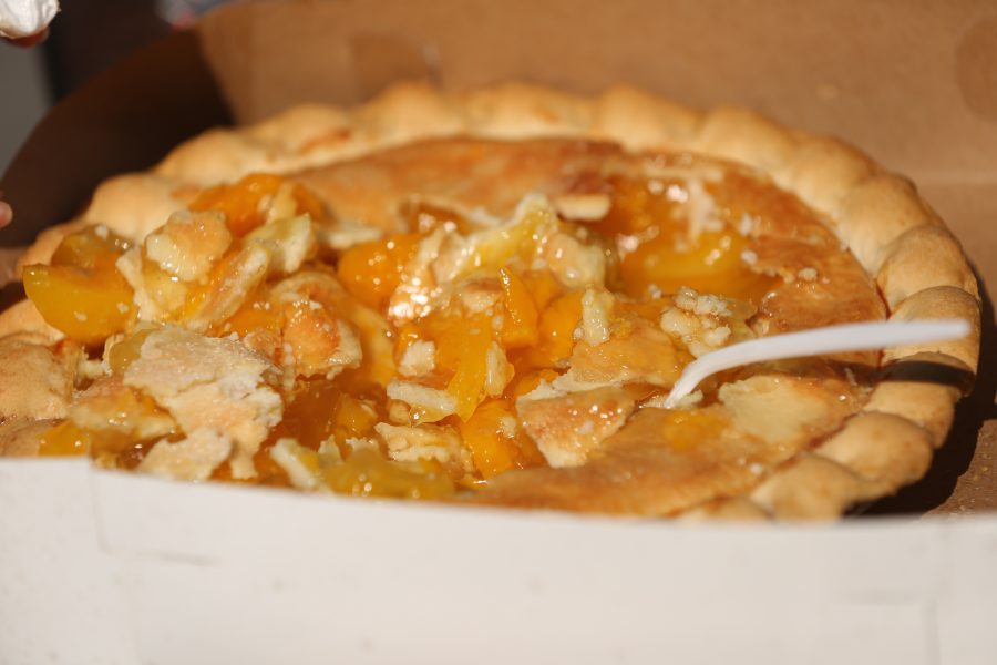 A peach pie sits on a table following the peach pie eating contest at the 2018 Fort Collins Peach Festival on Aug. 18.  (Forrest Czarnecki | The Collegian)