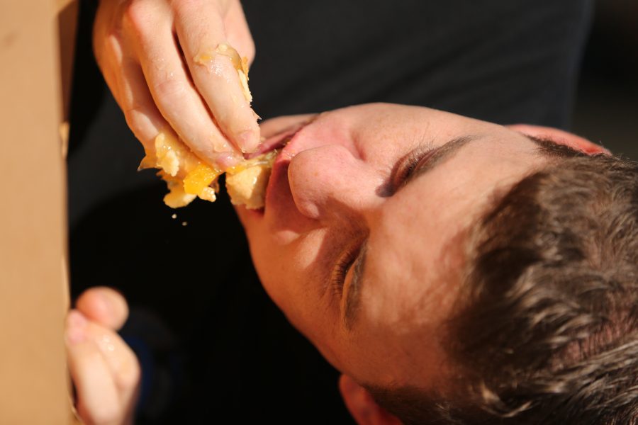 Jacob Ford competes in the peach pie eating contest at the 2018 Fort Collins Peach Festival on Aug. 18.  (Forrest Czarnecki | The Collegian)