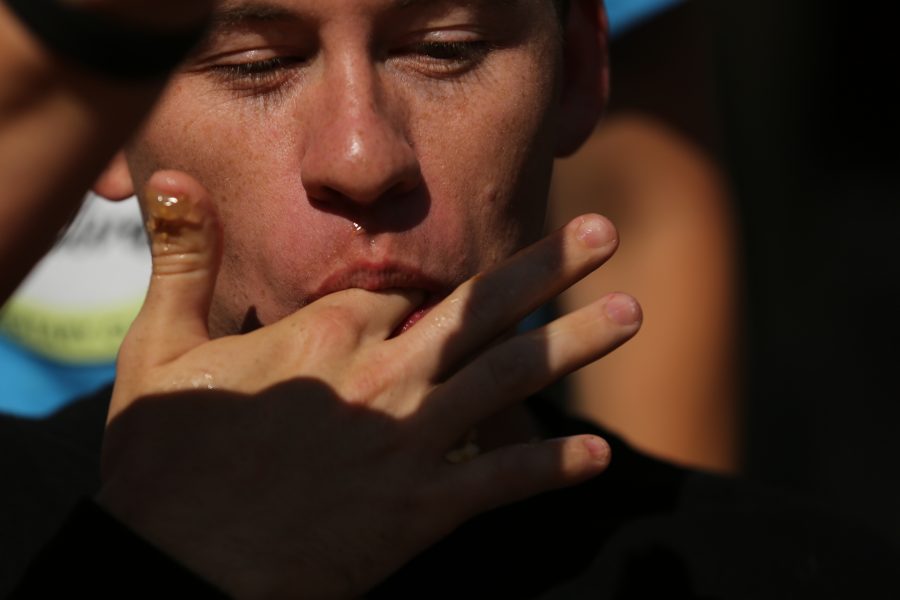 Jacob Ford licks his fingers after competing in the peach pie eating contest at the 2018 Fort Collins Peach Festival on Aug. 18.  (Forrest Czarnecki | The Collegian)