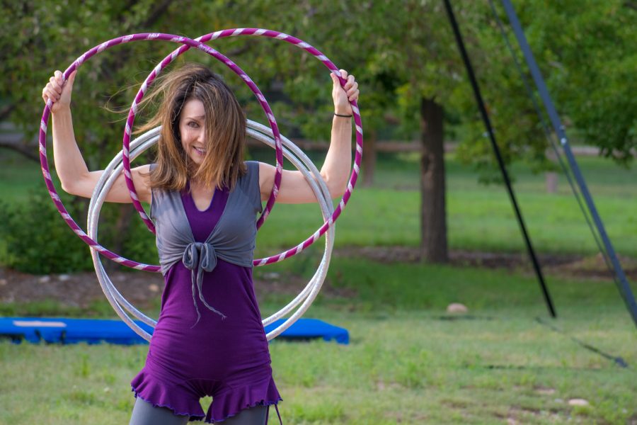 Lindy Zuroski, doing business as, Lindy Spindy hoop dances to represent the sunrise and everyone waking up from the night during A Midsummer Nights Fire Circus. Lindy has been performing with Spectra Circus Entertainment since 2016. She also has a husband and three children and is a pharmacist when she is not doing circus things. (Sara Graydon | Collegian)