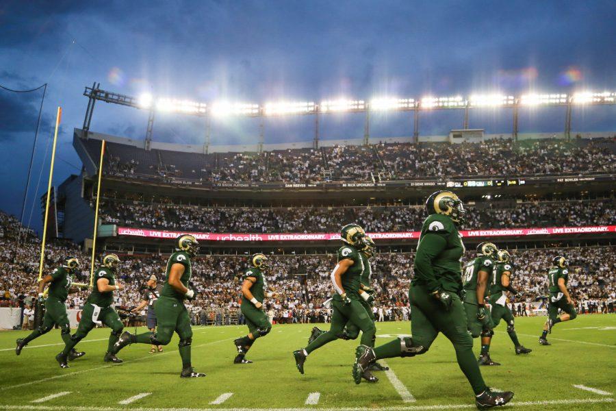 CSU Football players run out of the tunnel onto Broncos stadium during the start of Rocky Mountain Showdown. The Rams lost to the Buffs  13-45. (Tony Villalobos May | Collegian)