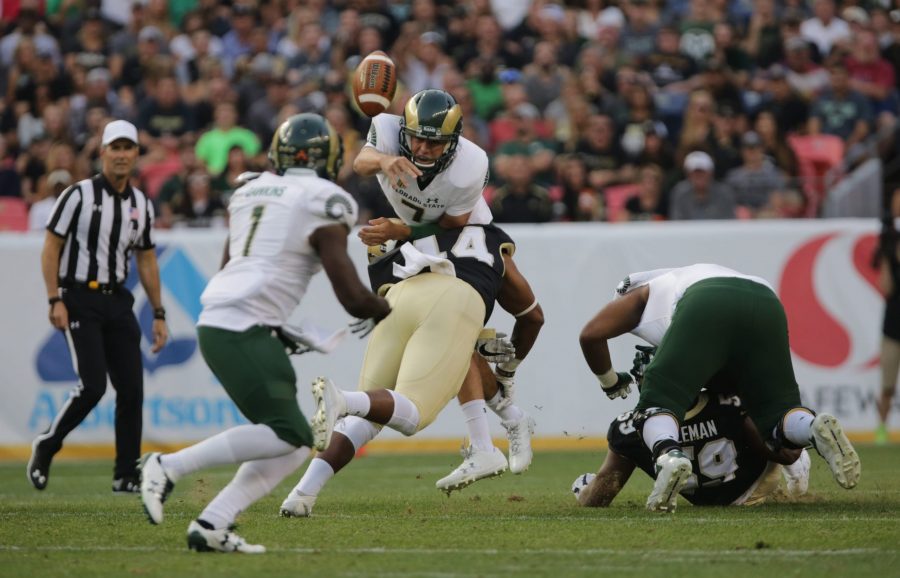 Quarterback Nick Stevens (7) is hit hard while throwing the ball to running back Dalyn Dawkins (1) during the Rocky Mountain Showdown. (Forest Czarnecki | Collegian)