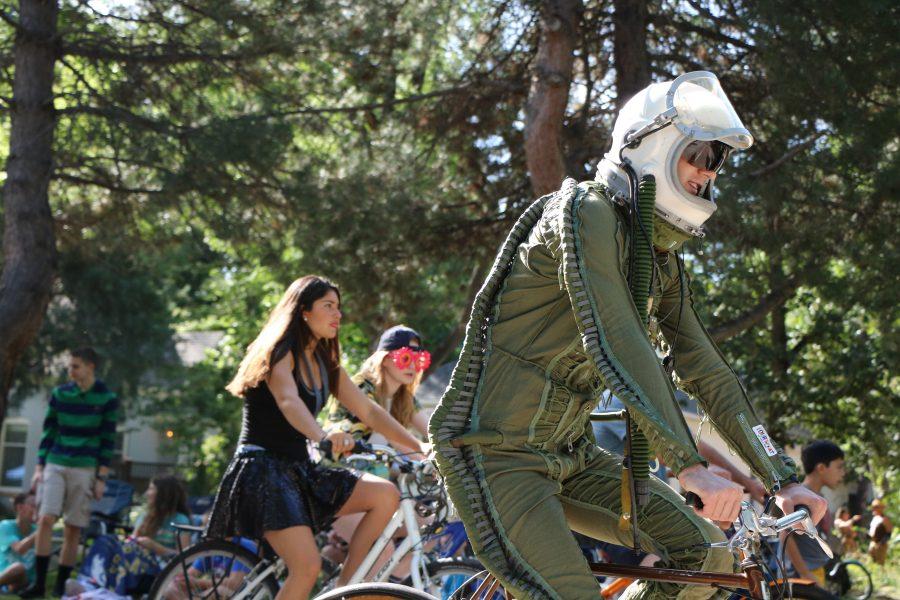 A participant passes by  dressed up as a space man while participating the Tour De Fat Parade. (Devin Cornelius | Collegian)