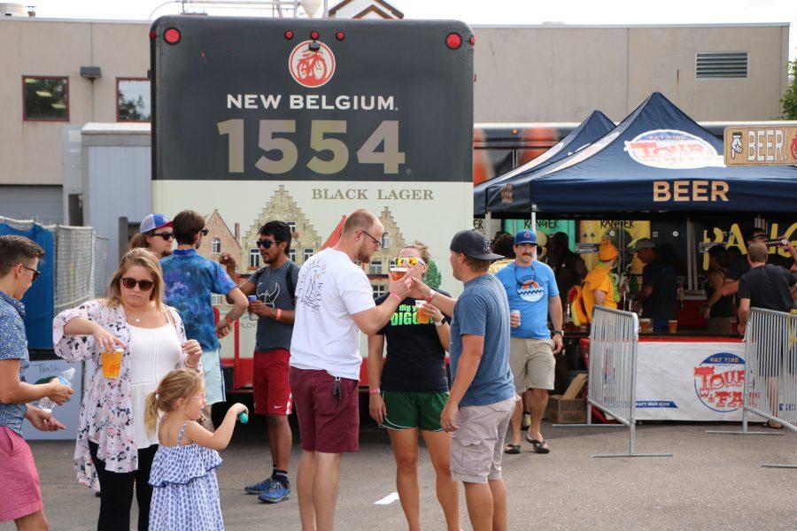 Some people discuss after getting their New Belgium beers. (Devin Cornelius | Collegian)
