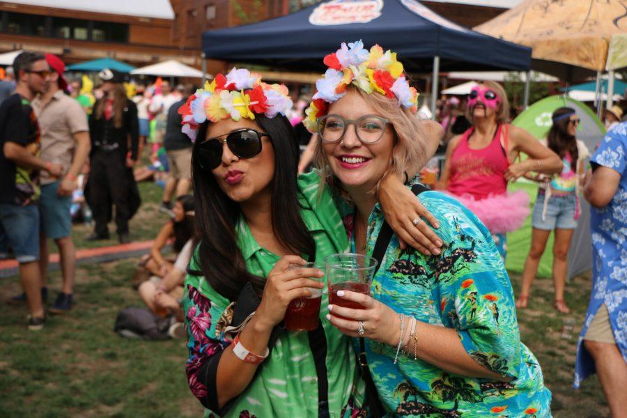 Cesilie K and Carly U pose with their beers while wating for the next act to arrive on stage. (Devin Cornelius | Collegian)