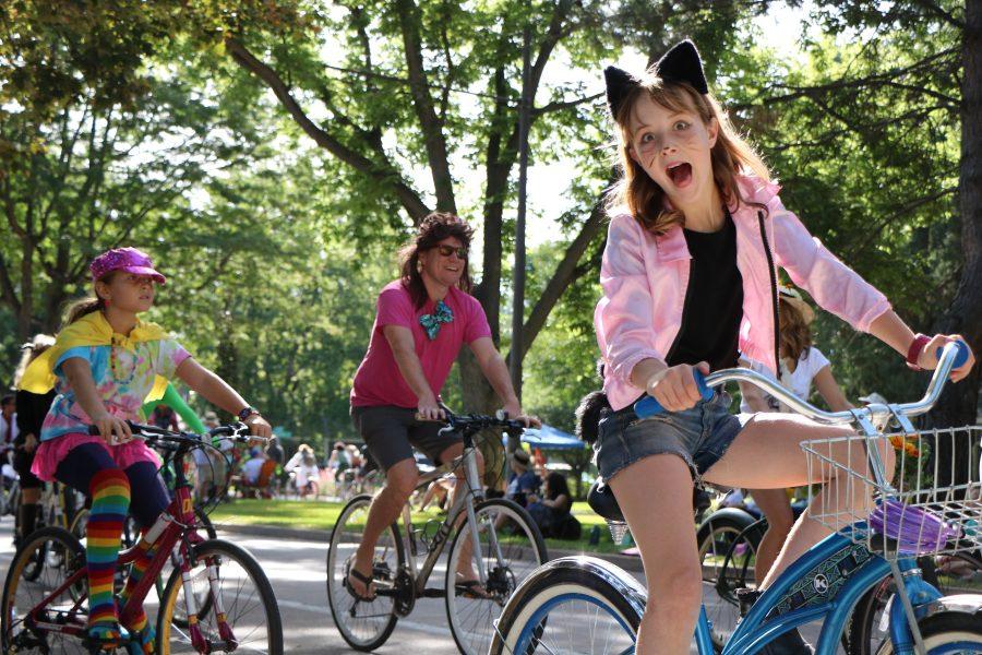 A prarade attendee makes a silly face as she passes by on her bike while participating in the Tour De Fat Parade(Devin Cornelius | Collegian)